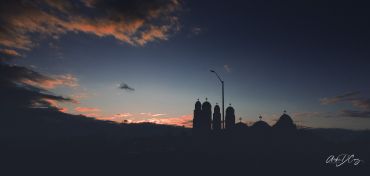 The Coptic Centre in Mississauga silhouetted against a fast-sinking sun